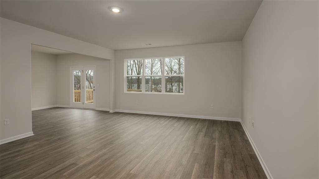 504 Bullock Pass Jefferson, GA 30549 - Photo 13 of 54 an empty room with wooden floor and windows