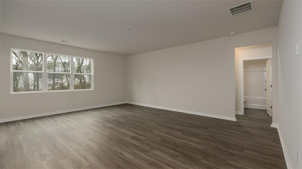 504 Bullock Pass Jefferson, GA 30549 - Photo 14 of 54 an empty room with wooden floor and windows
