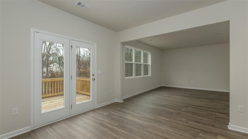 504 Bullock Pass Jefferson, GA 30549 - Photo 15 of 54 an empty room with wooden floor and windows