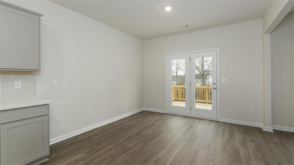 504 Bullock Pass Jefferson, GA 30549 - Photo 16 of 54 a view of an empty room with wooden floor and a window