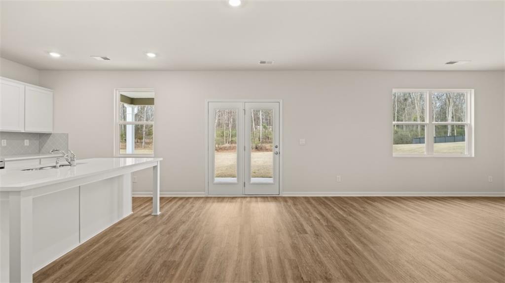 504 Bullock Pass Jefferson, GA 30549 - Photo 19 of 54 a view of a kitchen with wooden floor and a window