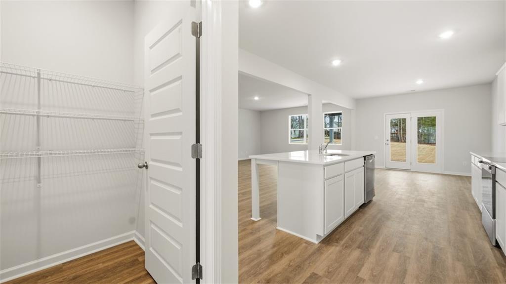 504 Bullock Pass Jefferson, GA 30549 - Photo 20 of 54 a open kitchen with white cabinets and wooden floor