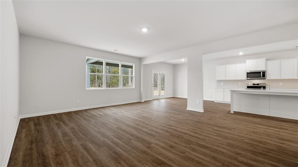 504 Bullock Pass Jefferson, GA 30549 - Photo 23 of 54 a view of an empty room with window and wooden floor