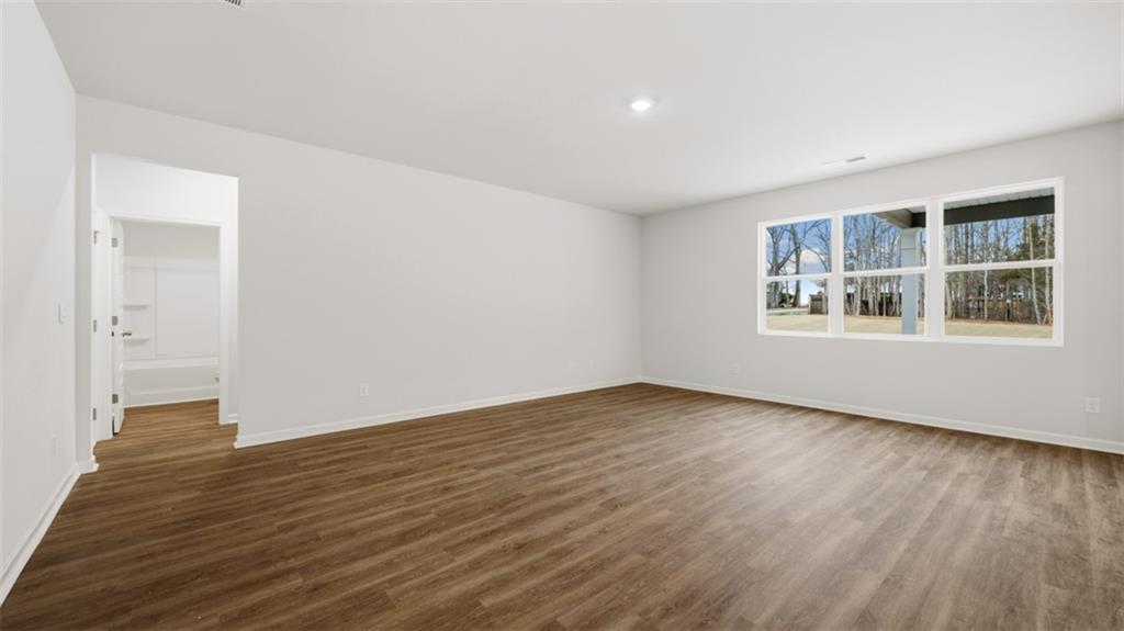 504 Bullock Pass Jefferson, GA 30549 - Photo 24 of 54 a view of an empty room with wooden floor and a window