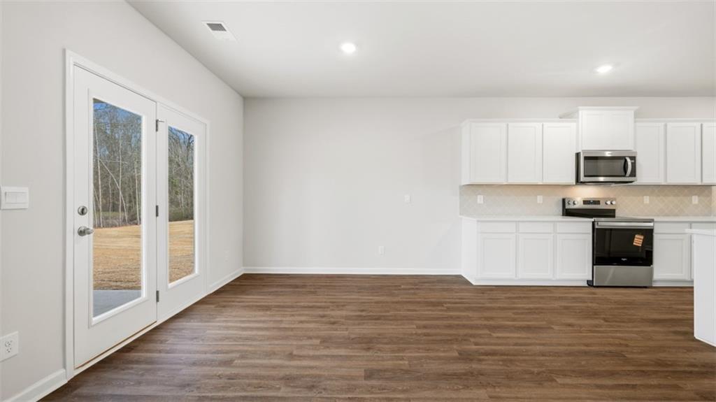 504 Bullock Pass Jefferson, GA 30549 - Photo 25 of 54 a view of kitchen with wooden floor and electronic appliances