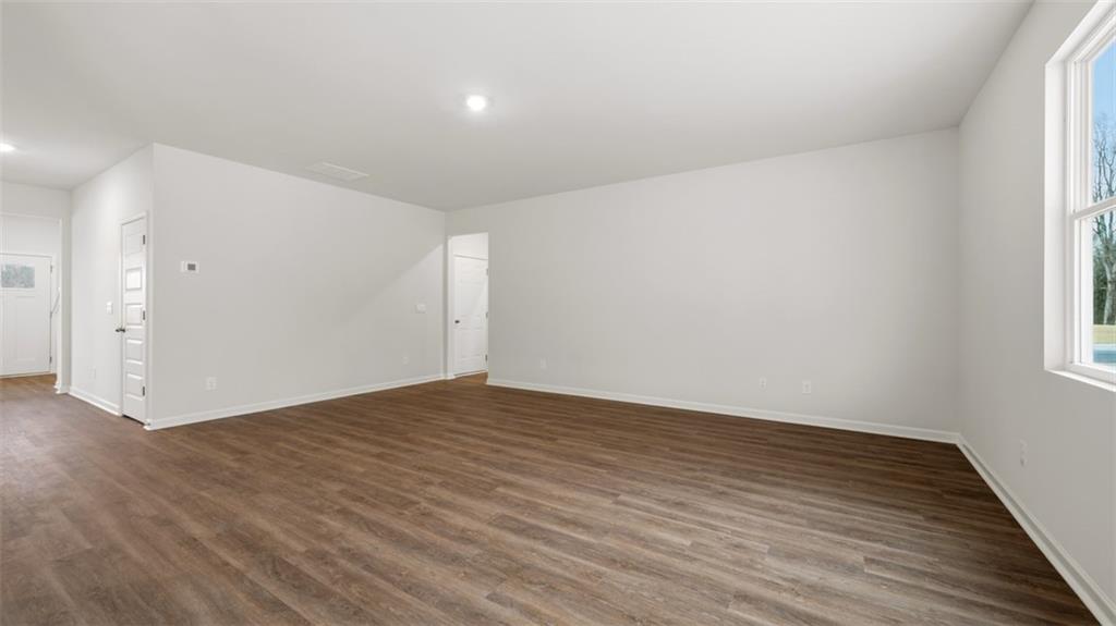 504 Bullock Pass Jefferson, GA 30549 - Photo 26 of 54 a view of an empty room with wooden floor and a window