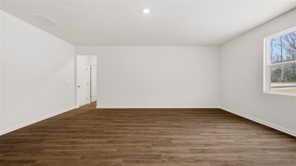 504 Bullock Pass Jefferson, GA 30549 - Photo 27 of 54 a view of an empty room with wooden floor and a window