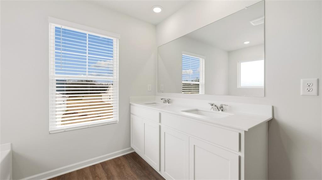 504 Bullock Pass Jefferson, GA 30549 - Photo 37 of 54 a bathroom with a sink a vanity and a window