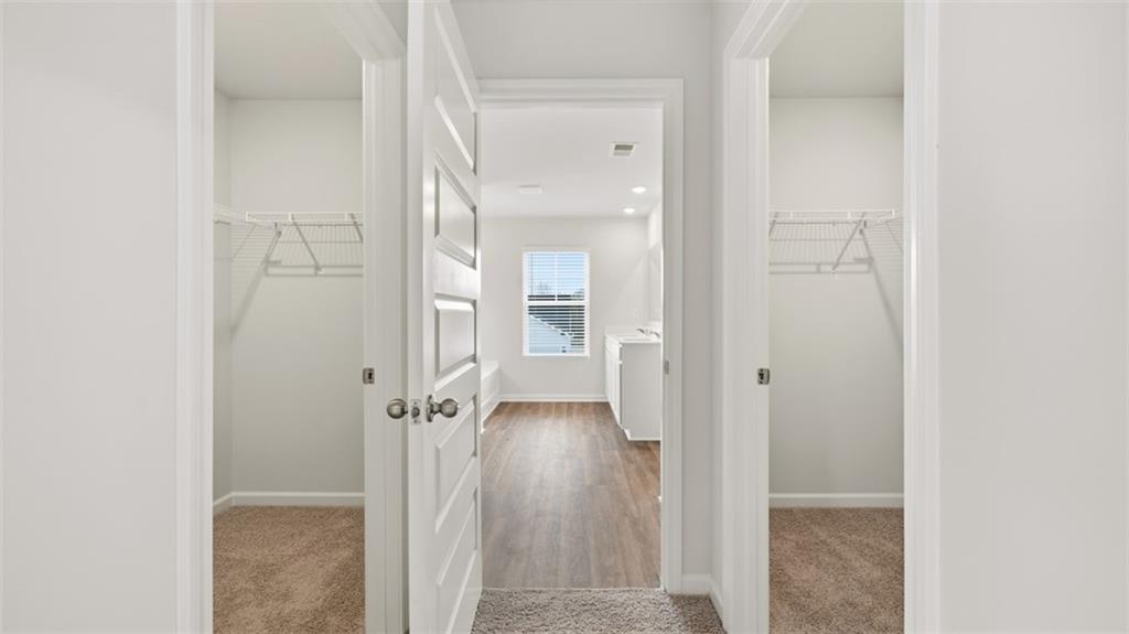 504 Bullock Pass Jefferson, GA 30549 - Photo 40 of 54 a view of a hallway with wooden floor and a bathroom