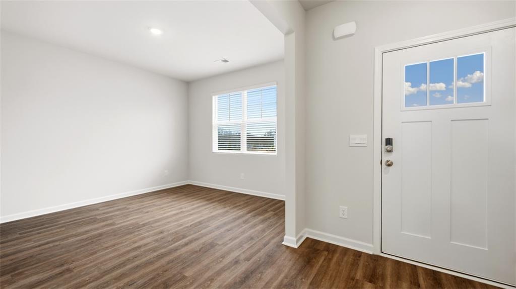 504 Bullock Pass Jefferson, GA 30549 - Photo 5 of 54 an empty room with wooden floor and windows