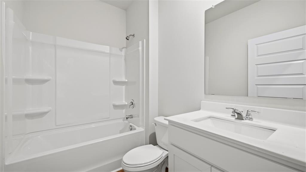 504 Bullock Pass Jefferson, GA 30549 - Photo 51 of 54 a bathroom with a granite countertop sink toilet and shower