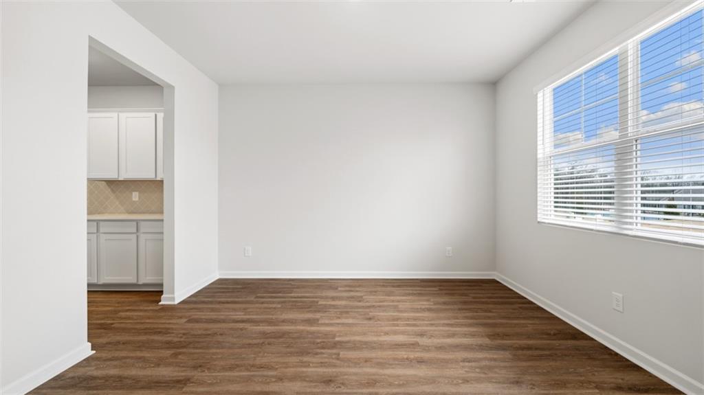 504 Bullock Pass Jefferson, GA 30549 - Photo 6 of 54 a view of empty room with wooden floor and fan
