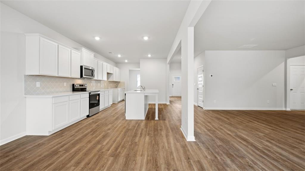 504 Bullock Pass Jefferson, GA 30549 - Photo 10 of 54 a kitchen with white cabinets and stainless steel appliances