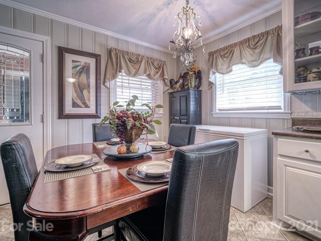 2823 Bettis Road Grover, NC 28073 - Photo 11 of 27 a dining room with furniture a chandelier and window