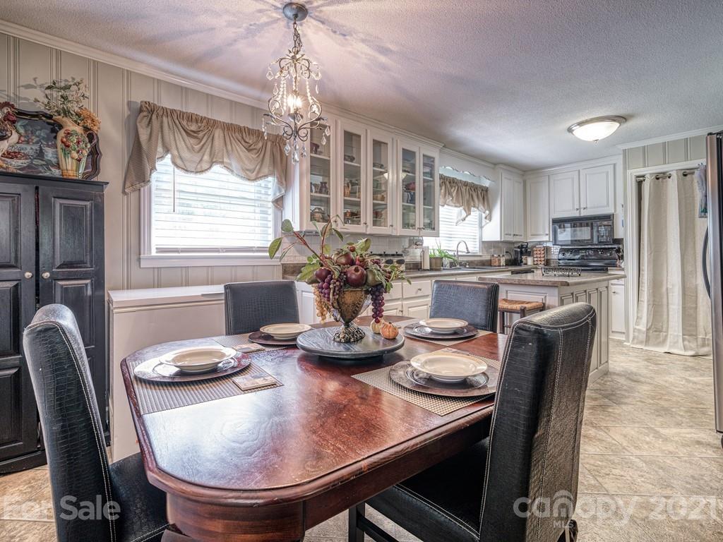 2823 Bettis Road Grover, NC 28073 - Photo 13 of 27 a dining room with furniture a chandelier and window