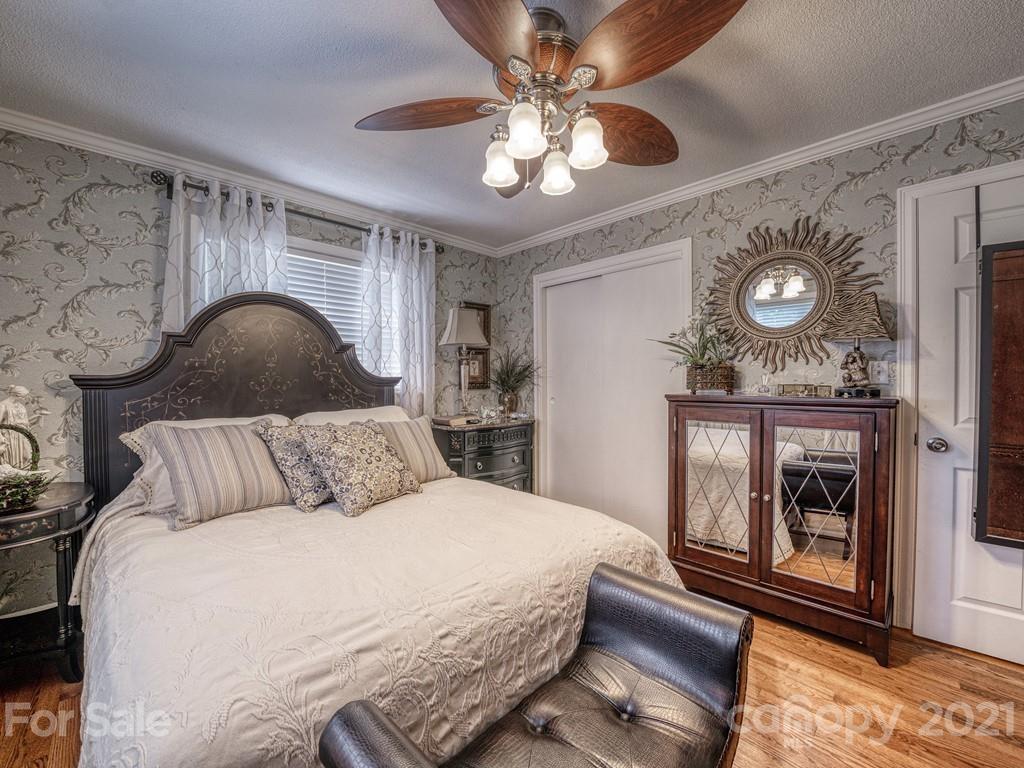 2823 Bettis Road Grover, NC 28073 - Photo 21 of 27 a bedroom with a large bed and a chandelier