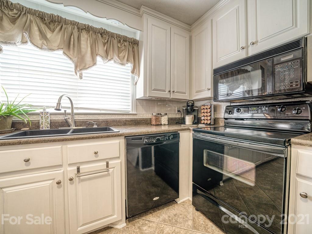 2823 Bettis Road Grover, NC 28073 - Photo 7 of 27 a kitchen with granite countertop a stove sink and cabinets