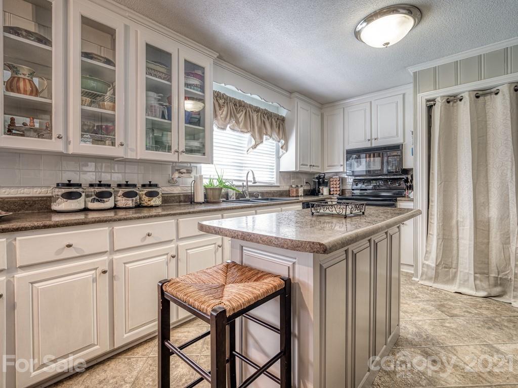2823 Bettis Road Grover, NC 28073 - Photo 10 of 27 a kitchen with stainless steel appliances granite countertop a stove a sink refrigerator and cabinets