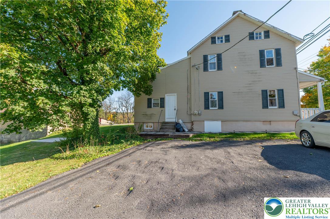 1261 State Street, Unit C Mertztown, PA 19539 - Photo 13 of 13 a front view of a house with a yard and garage