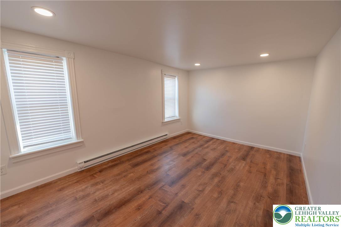1261 State Street, Unit C Mertztown, PA 19539 - Photo 5 of 13 an empty room with wooden floor and windows