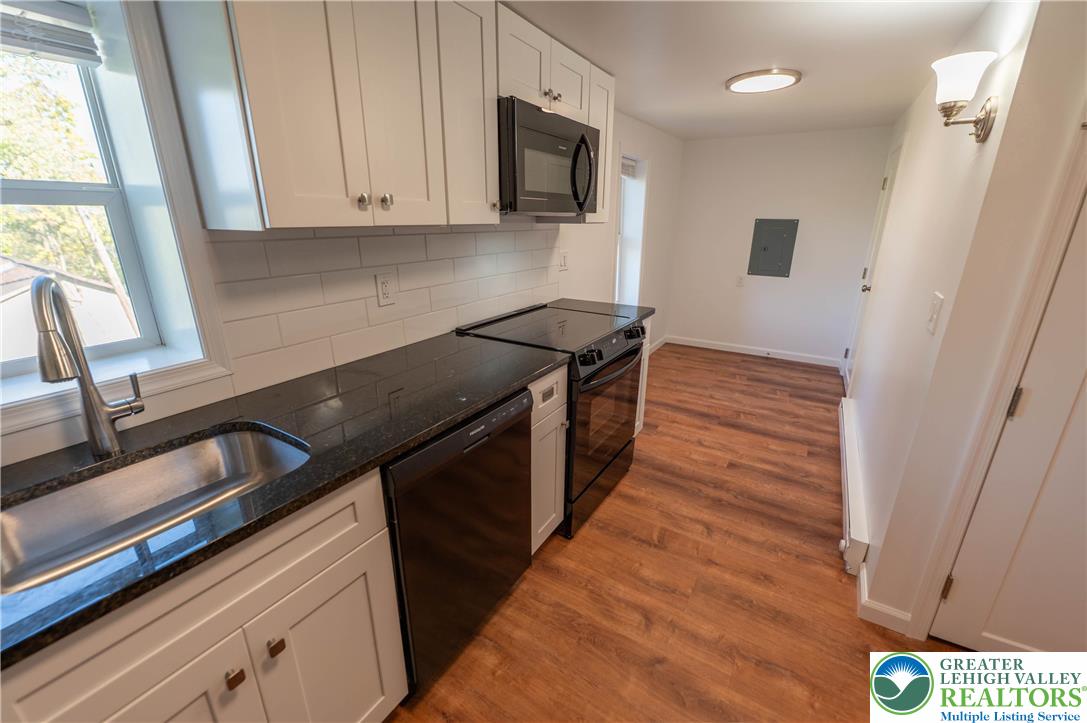 1261 State Street, Unit C Mertztown, PA 19539 - Photo 8 of 13 a kitchen with a stove and a microwave