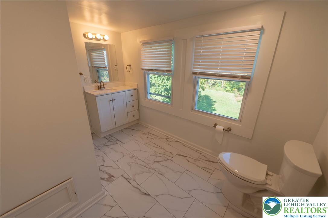 1261 State Street, Unit C Mertztown, PA 19539 - Photo 10 of 13 a bathroom with a sink a toilet and tub