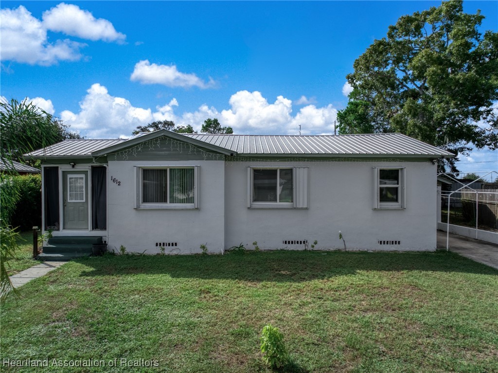 1612 Hitakee Avenue Sebring, FL 33870 - Photo 1 of 32 a view of a house with a yard