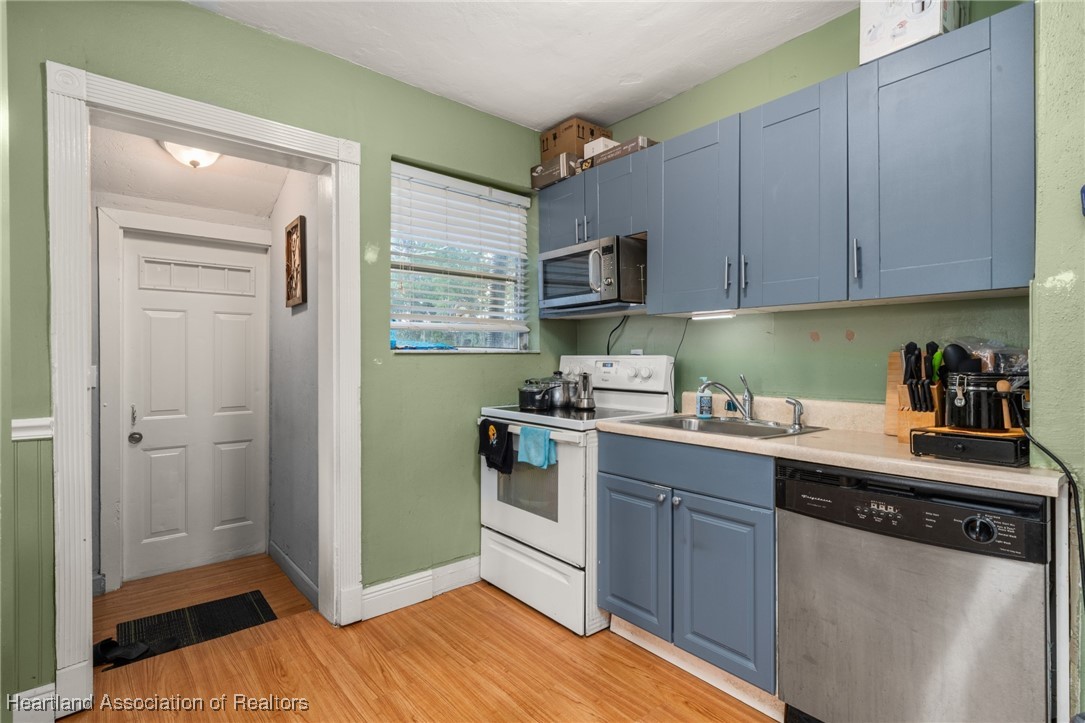 1612 Hitakee Avenue Sebring, FL 33870 - Photo 12 of 32 a kitchen with stainless steel appliances granite countertop a refrigerator and a sink
