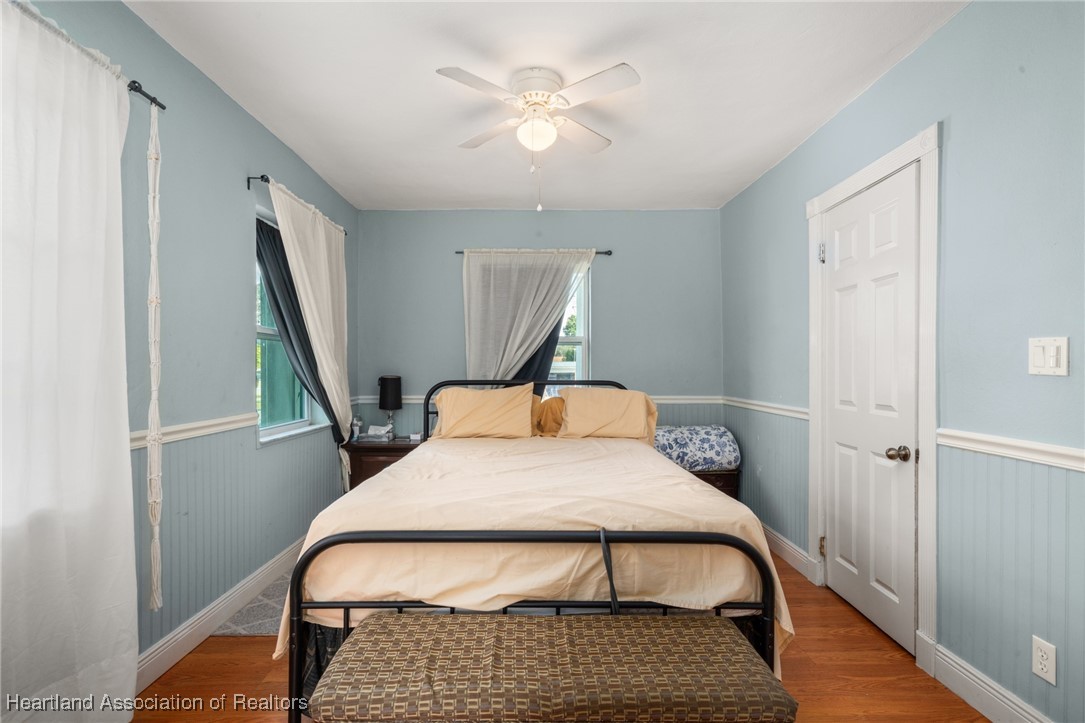 1612 Hitakee Avenue Sebring, FL 33870 - Photo 15 of 32 a bedroom with a bed a dresser and wooden floor