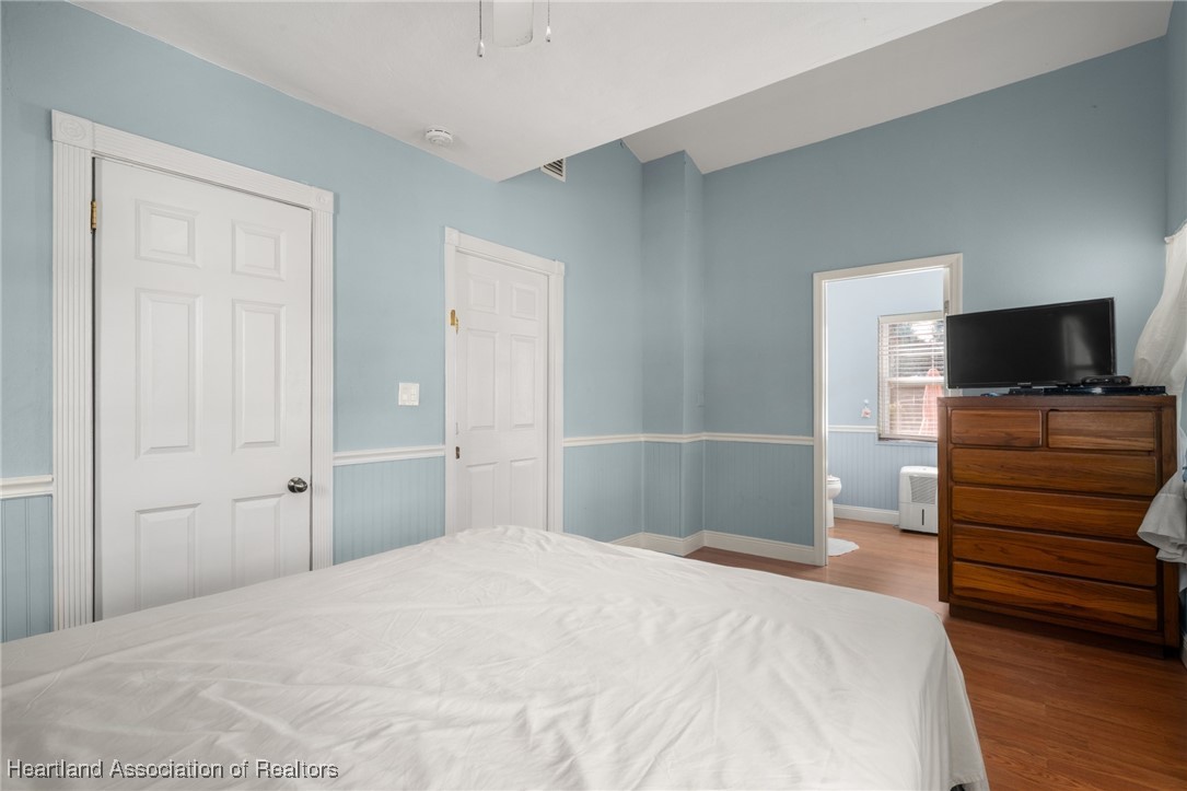 1612 Hitakee Avenue Sebring, FL 33870 - Photo 16 of 32 a bedroom with a bed and wooden floor