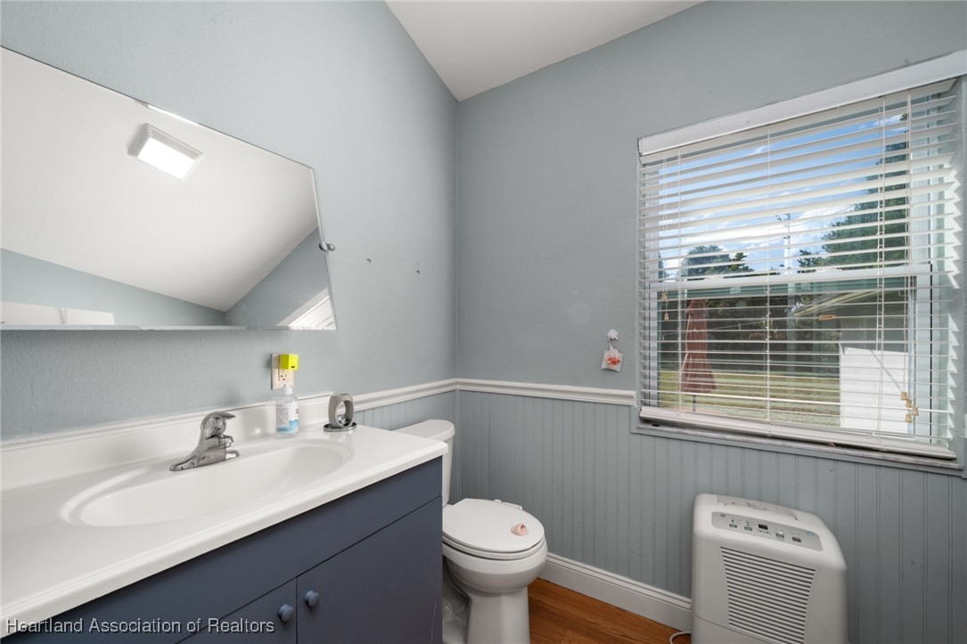 1612 Hitakee Avenue Sebring, FL 33870 - Photo 18 of 32 a bathroom with a sink vanity mirror and toilet