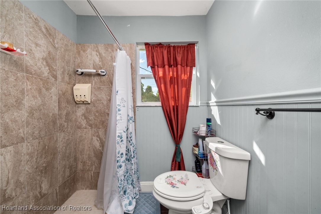 1612 Hitakee Avenue Sebring, FL 33870 - Photo 25 of 32 a white toilet sitting next to a shower curtain