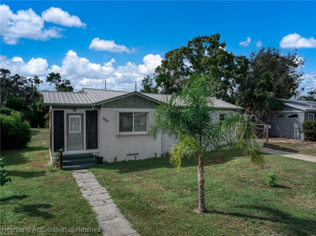 1612 Hitakee Avenue Sebring, FL 33870 - Photo 30 of 32 a view of a house with a yard