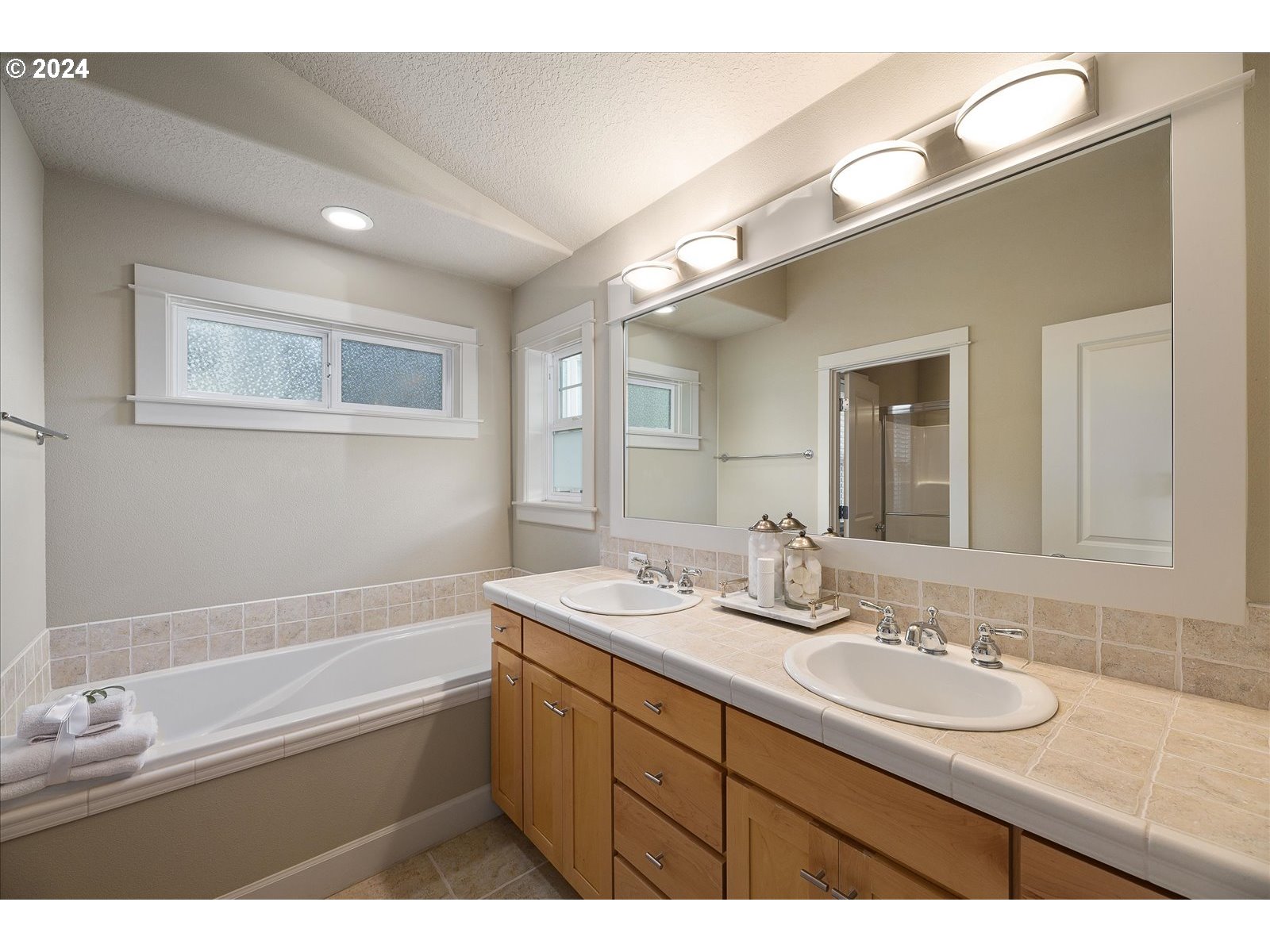 2224 Lucerne Place West Linn, OR 97068 - Photo 24 of 26 a bathroom with a granite countertop sink mirror and bathtub