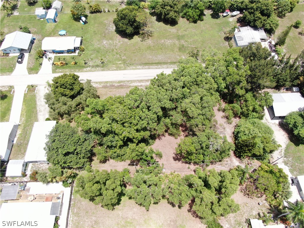 5855 Sailfish Road Bokeelia, FL 33922 - Photo 7 of 9 a view of a lake with large trees