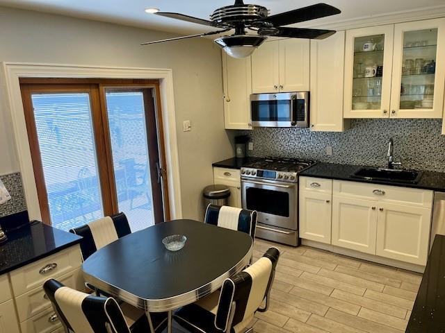 3201 Fillmore Avenue Brooklyn, NY 11234 - Photo 2 of 16 a kitchen with stainless steel appliances granite countertop a stove a microwave a dining table and chairs