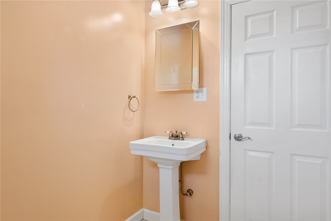 1509 869 Anderson, SC 29621 - Photo 25 of 45 A compact lavatory features a pedestal sink and bright overhead lighting, offering practical elegance.