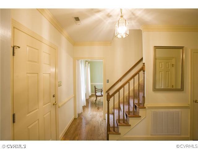 Foyer - Foyer features chair rail, crown molding,