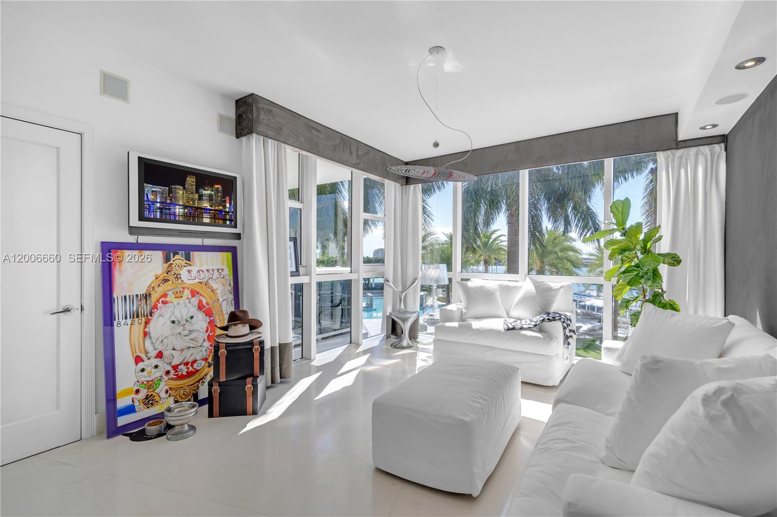 400 Alton Road, Unit 706 Miami Beach, FL 33139 - Photo 12 of 15 a living room with furniture and a large window