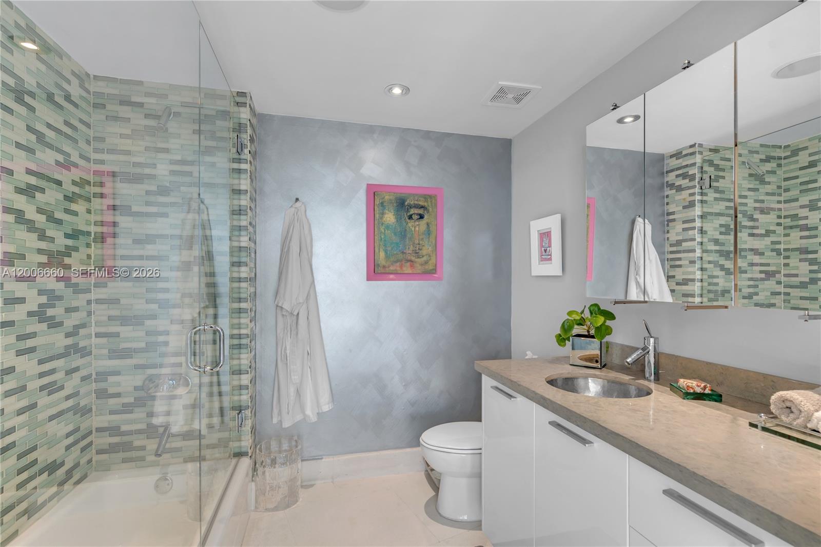 400 Alton Road, Unit 706 Miami Beach, FL 33139 - Photo 13 of 15 a bathroom with a granite countertop sink toilet and shower