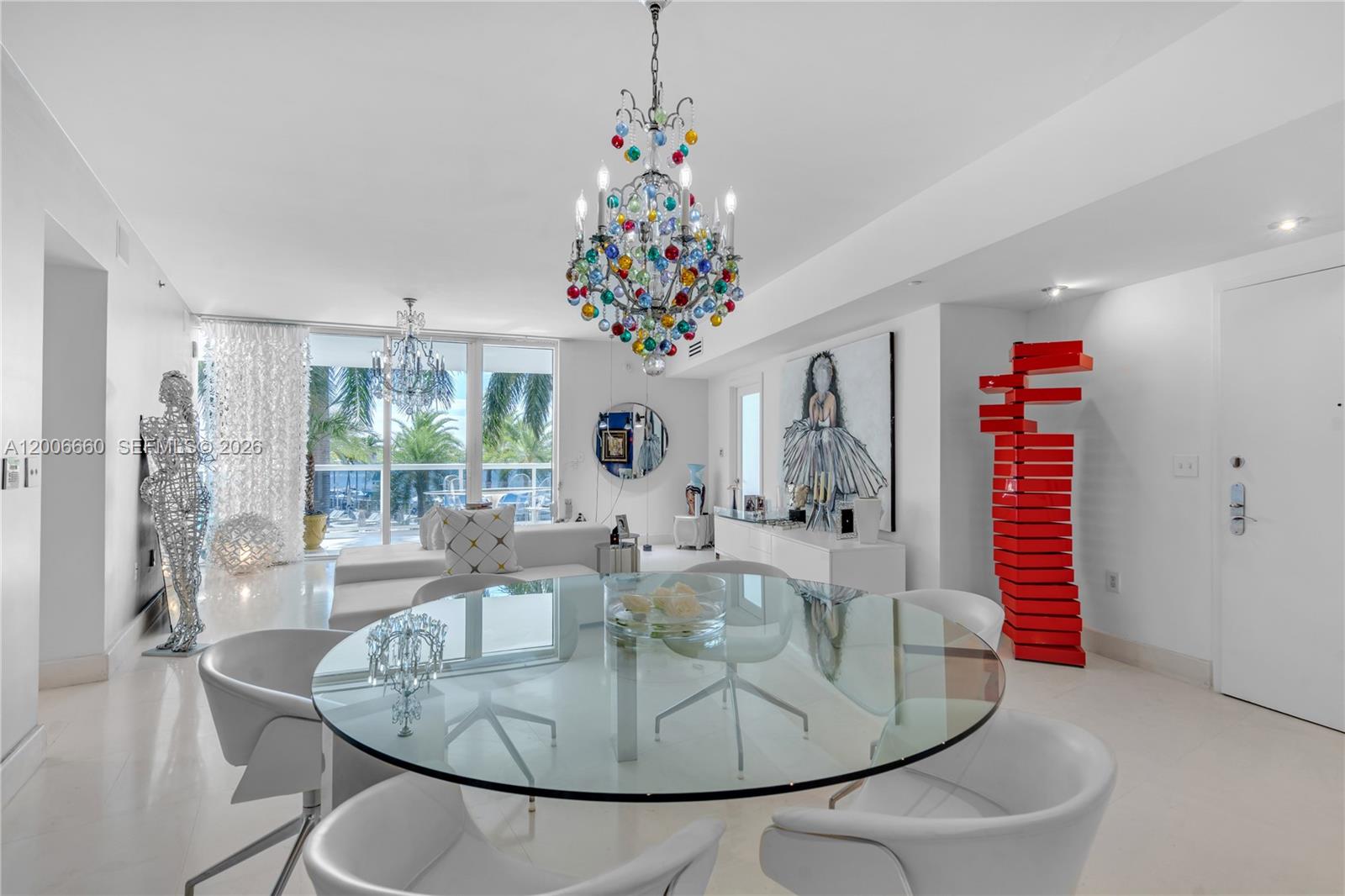 400 Alton Road, Unit 706 Miami Beach, FL 33139 - Photo 2 of 15 a living room with furniture and a chandelier