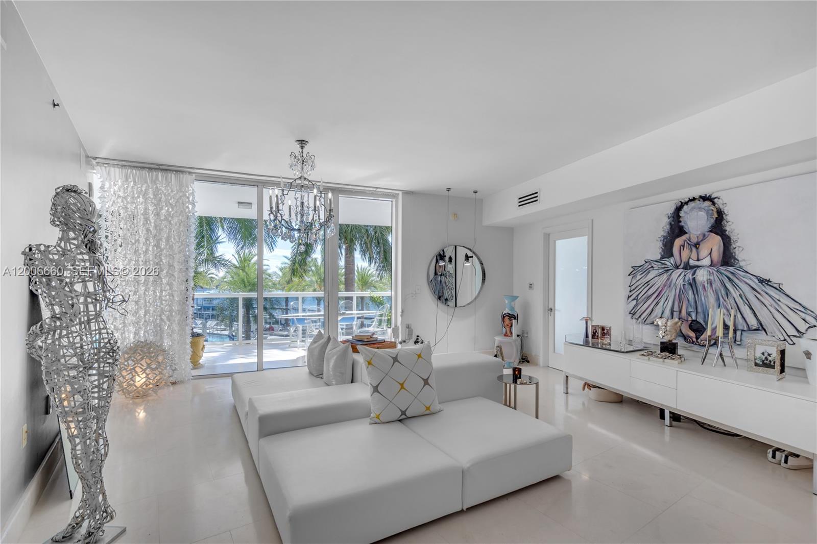 400 Alton Road, Unit 706 Miami Beach, FL 33139 - Photo 3 of 15 a living room with furniture and a table