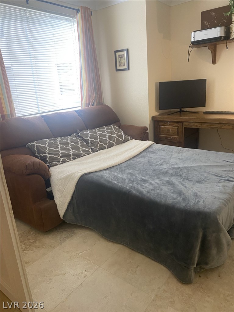 210 East Flamingo Road, Unit 137 Las Vegas, NV 89169 - Photo 13 of 32 A comfortable bedroom with a sofa that converts into a bed, offering practical versatility.