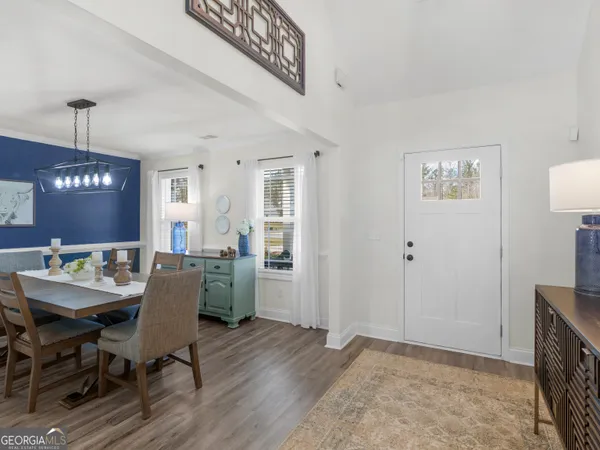 a view of a dining room with furniture window and wooden floor
