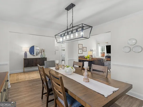 a view of a dining room with furniture window and wooden floor