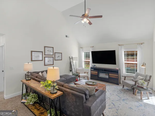 a living room with furniture rug and wooden floor