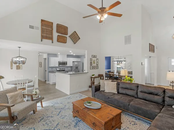 a view of a dining room with furniture wooden floor and chandelier