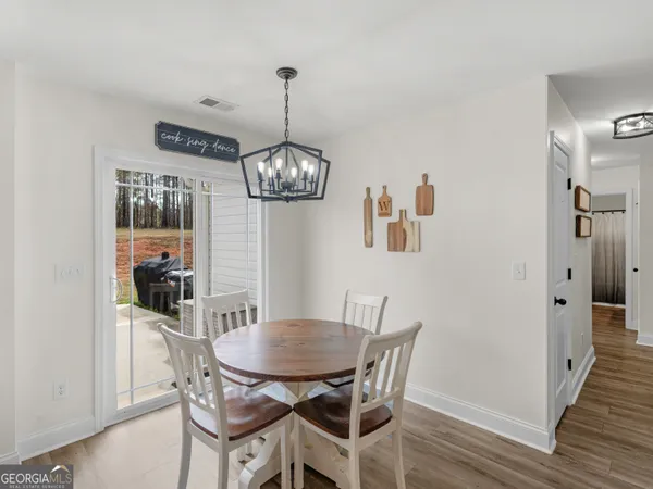 a view of a dining room with furniture window and wooden floor