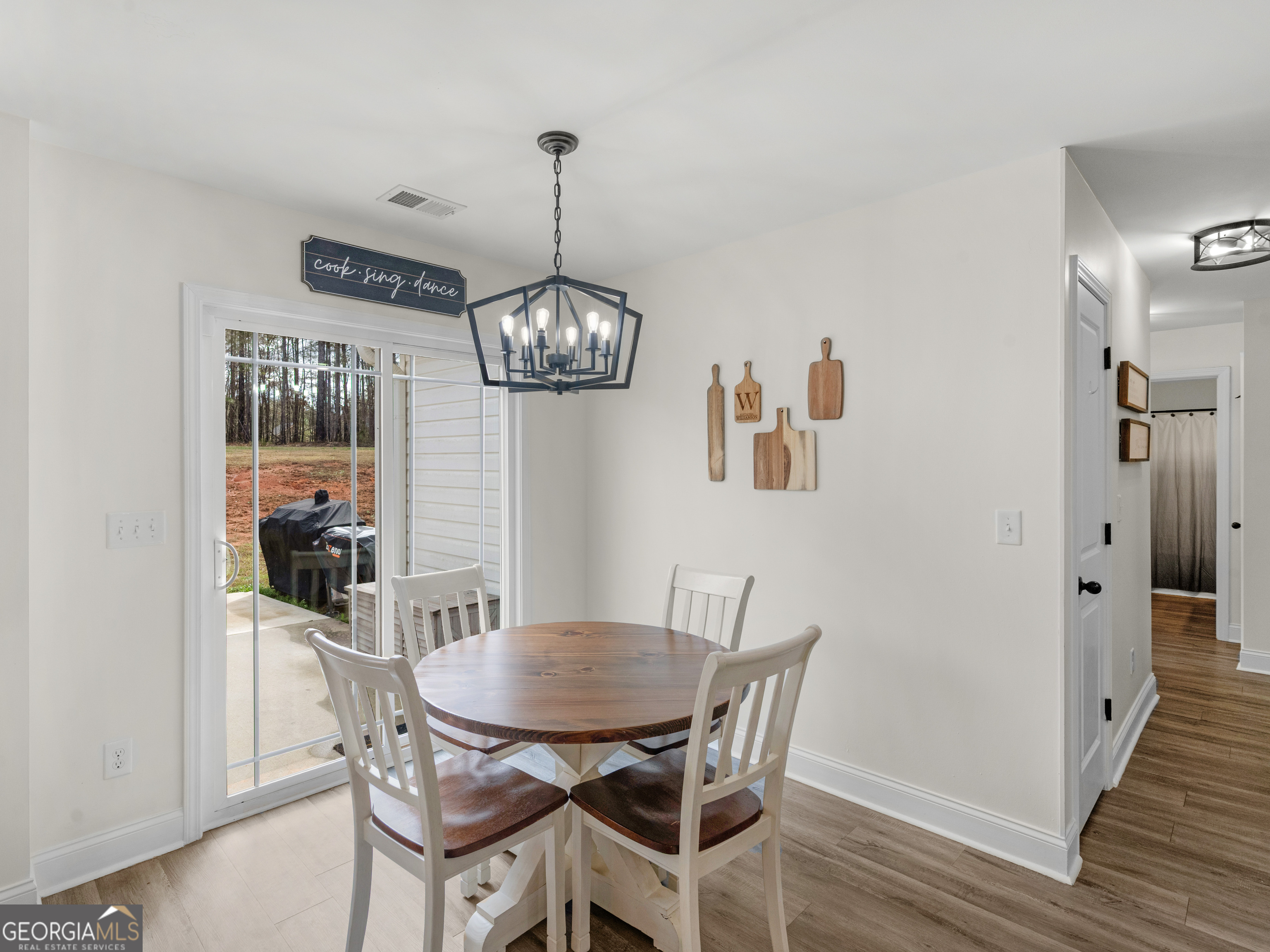 119 Mylee Cove Barnesville, GA 30204 - Photo 18 of 57 a view of a dining room with furniture wooden floor and chandelier