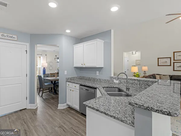 a kitchen with stainless steel appliances granite countertop a stove a refrigerator and a microwave